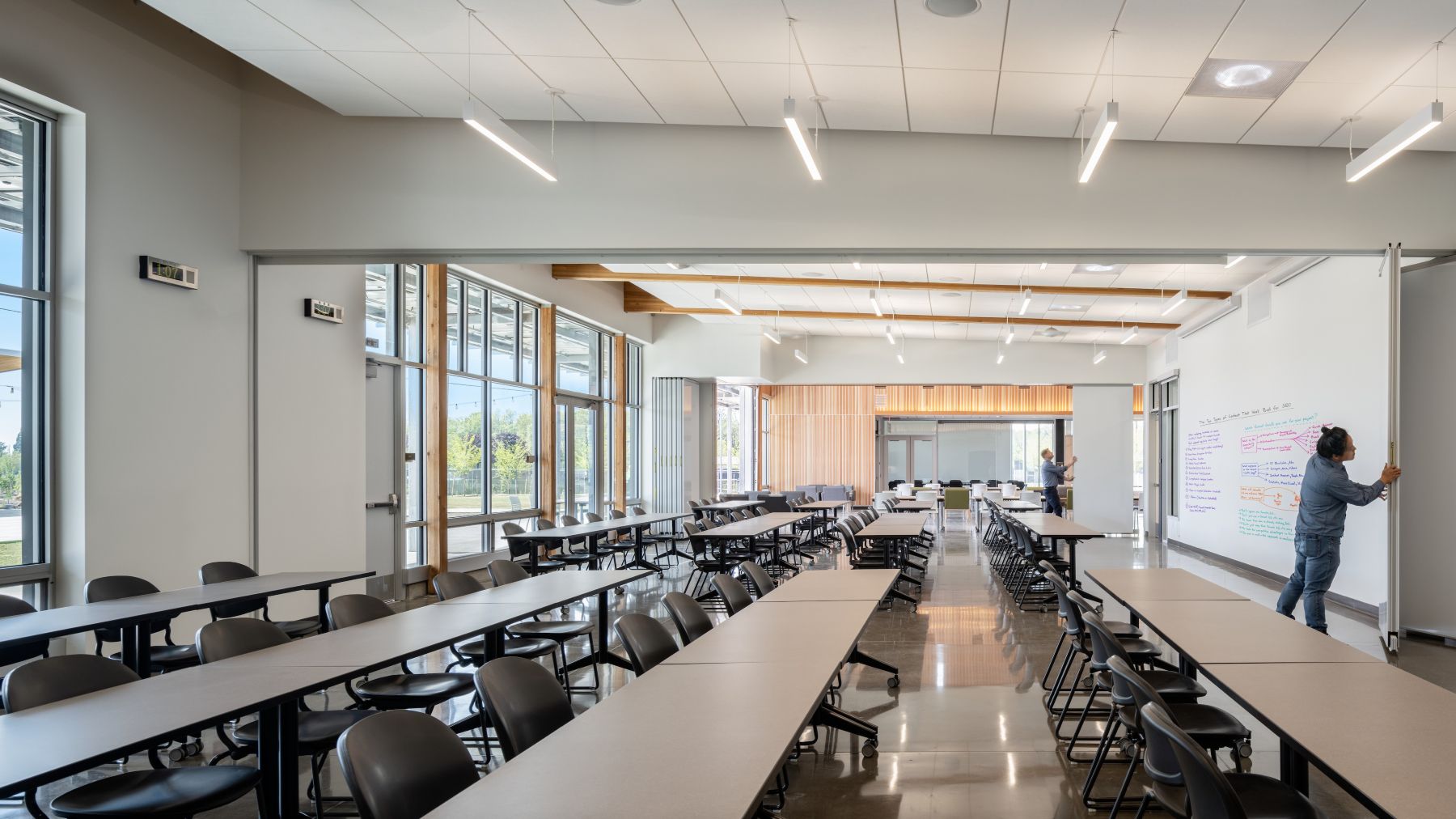 A flexible classroom at the Chemeketa Agriculture Complex opens into adjacent learning spaces, with movable partitions, abundant daylight, and writable walls.