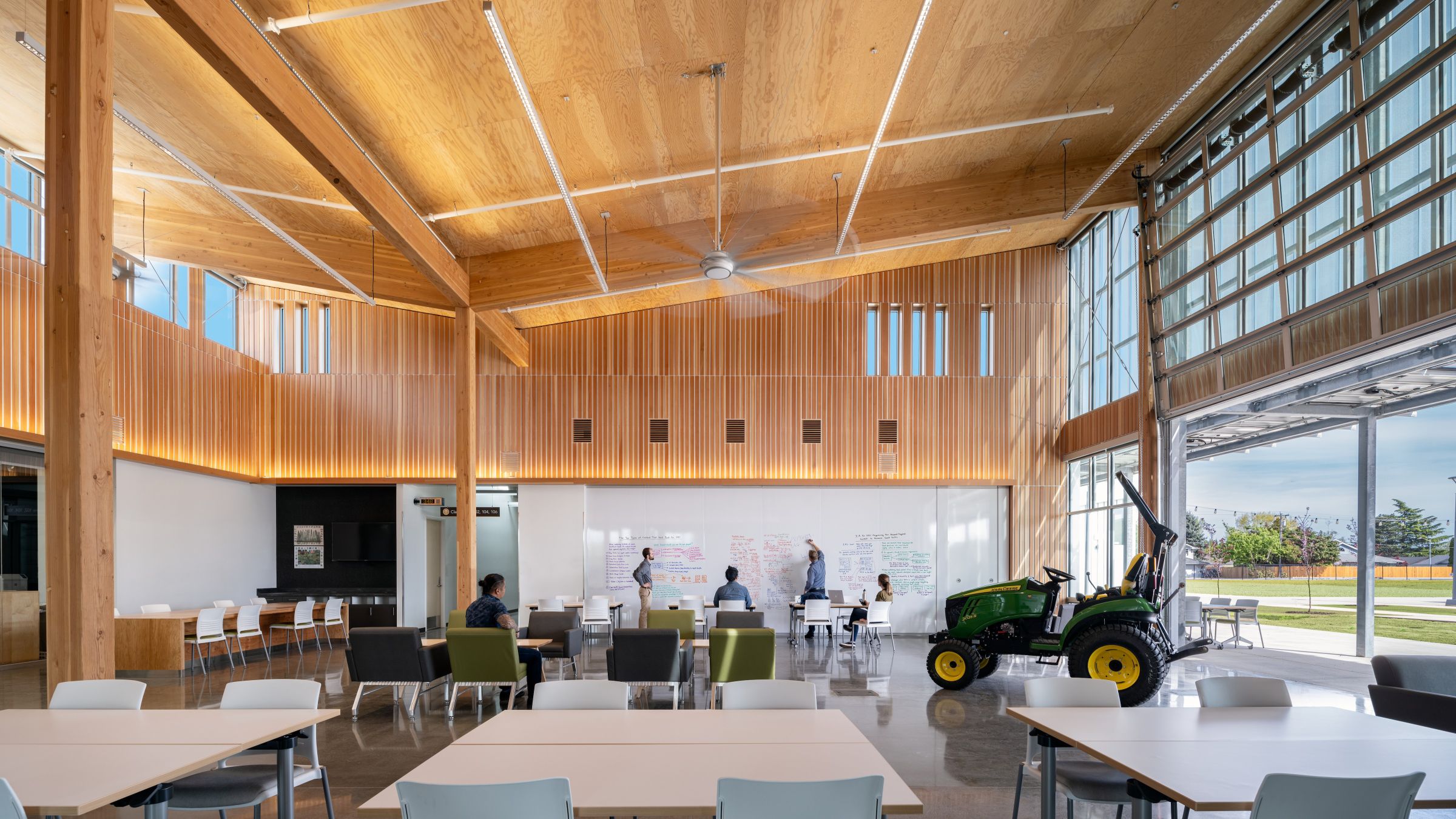 Students collaborate in the Chemeketa Agriculture Complex’s open learning hub, featuring exposed mass timber, flexible seating, a writable wall, and direct outdoor access.