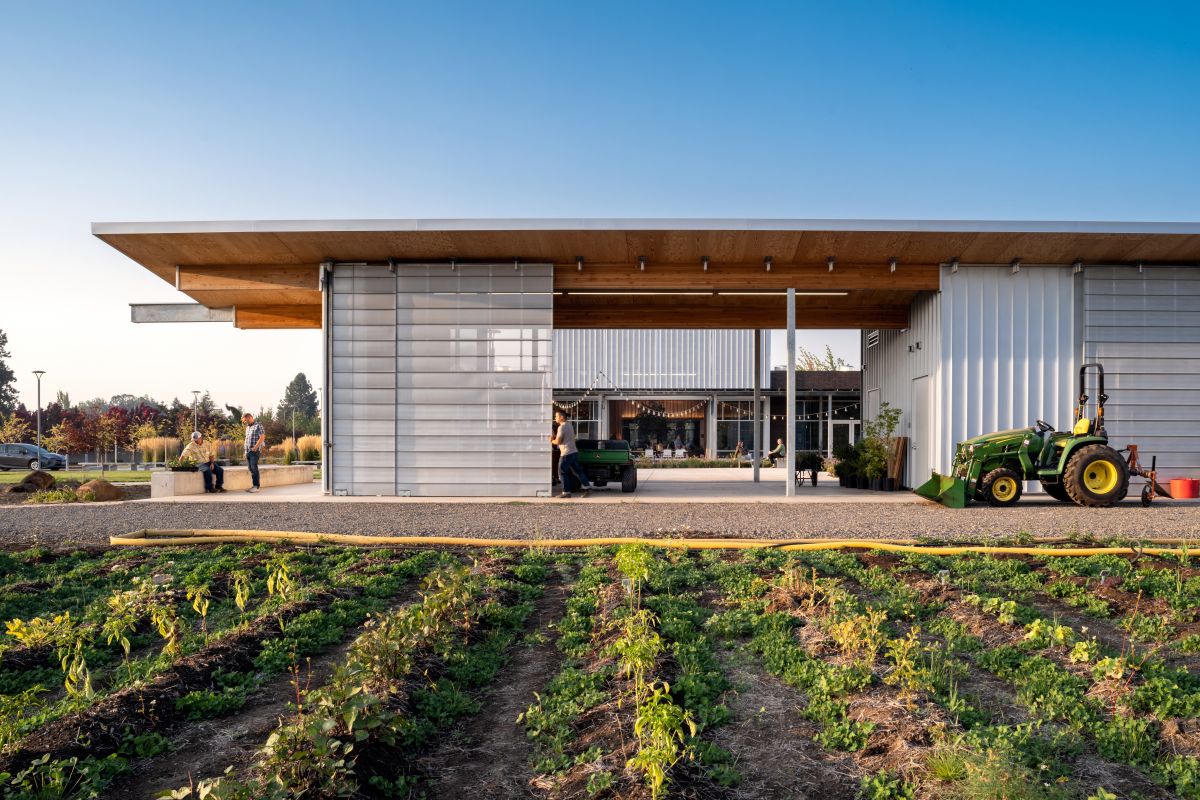 The Chemeketa Agriculture Complex pavilion opens directly to cultivated learning fields, connecting hands-on agricultural education with flexible covered workspace.