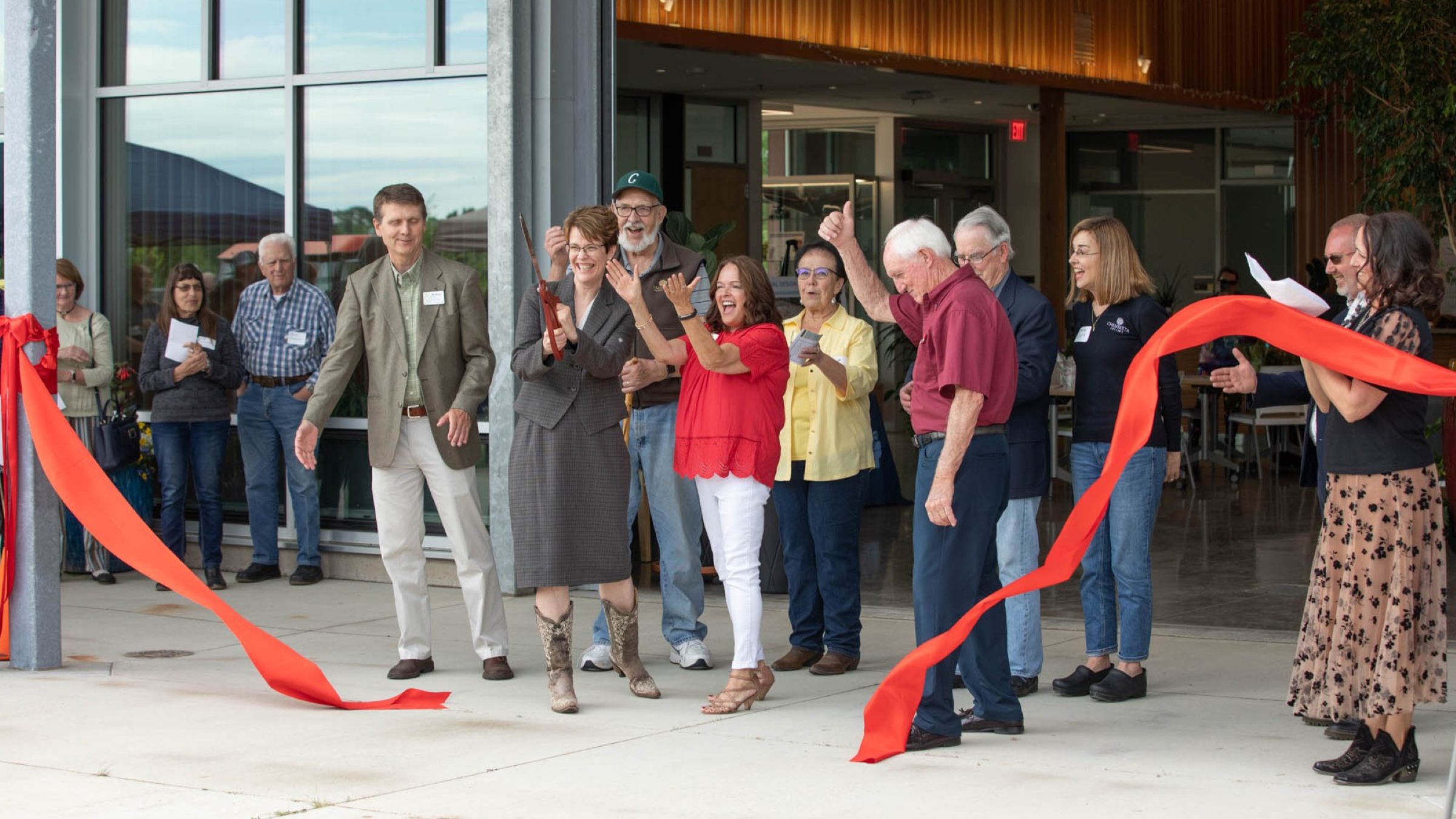 Project partners celebrate the Chemeketa Agriculture Complex opening during a ribbon-cutting ceremony outside the new learning facility.