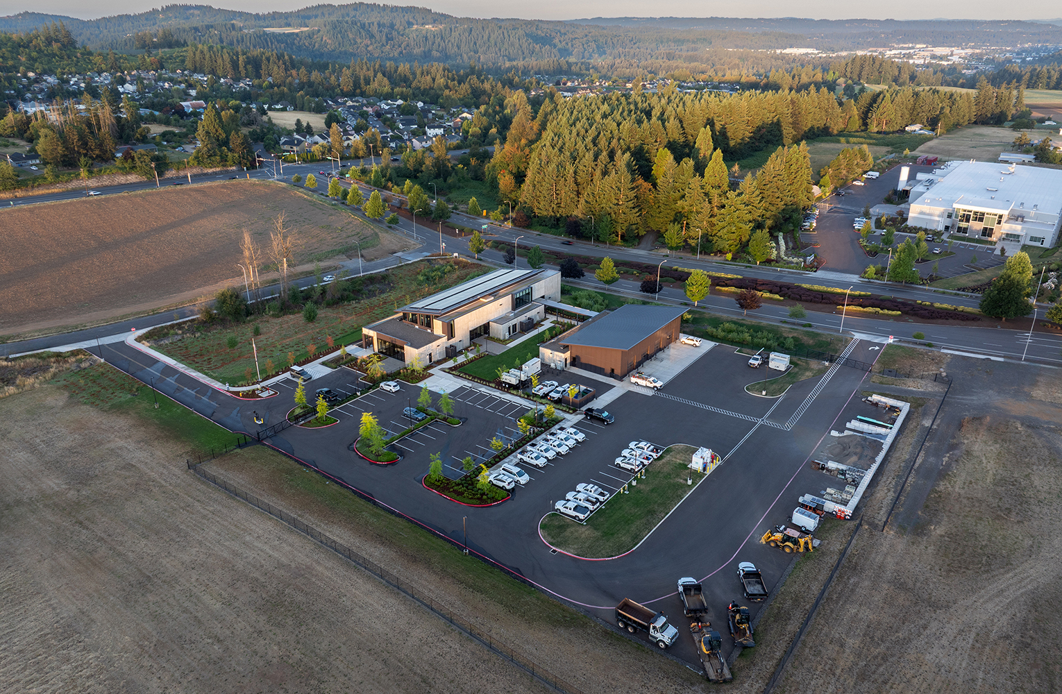 An aerial view of Sunrise Water Authority’s full campus, showing the administrative building, operations shop, fleet yard, and parking set alongside the restored wetland and surrounding hillsides.