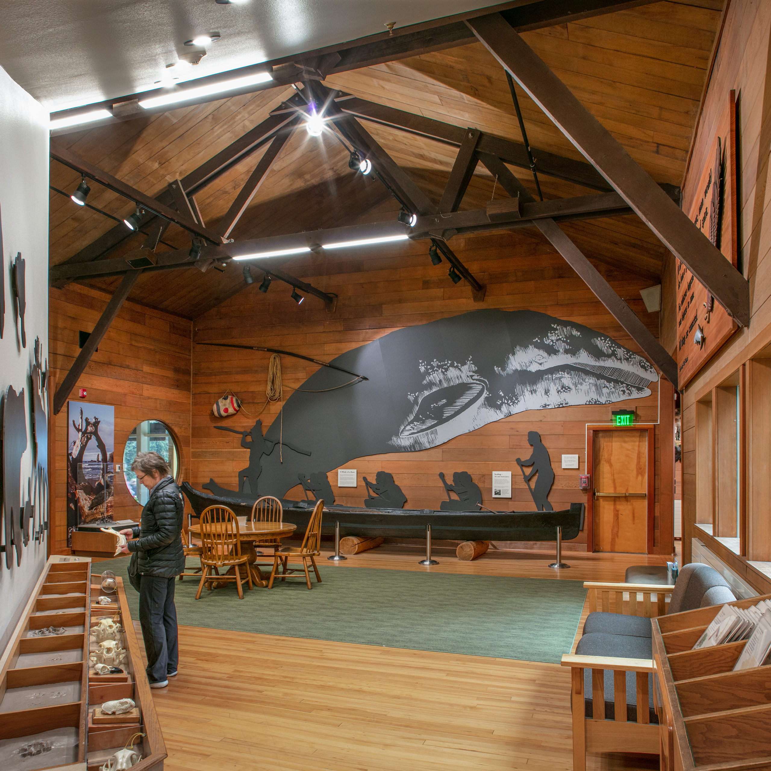 An exhibit at the Olympic National Park visitors center displaying a huge whale and people in a canoe