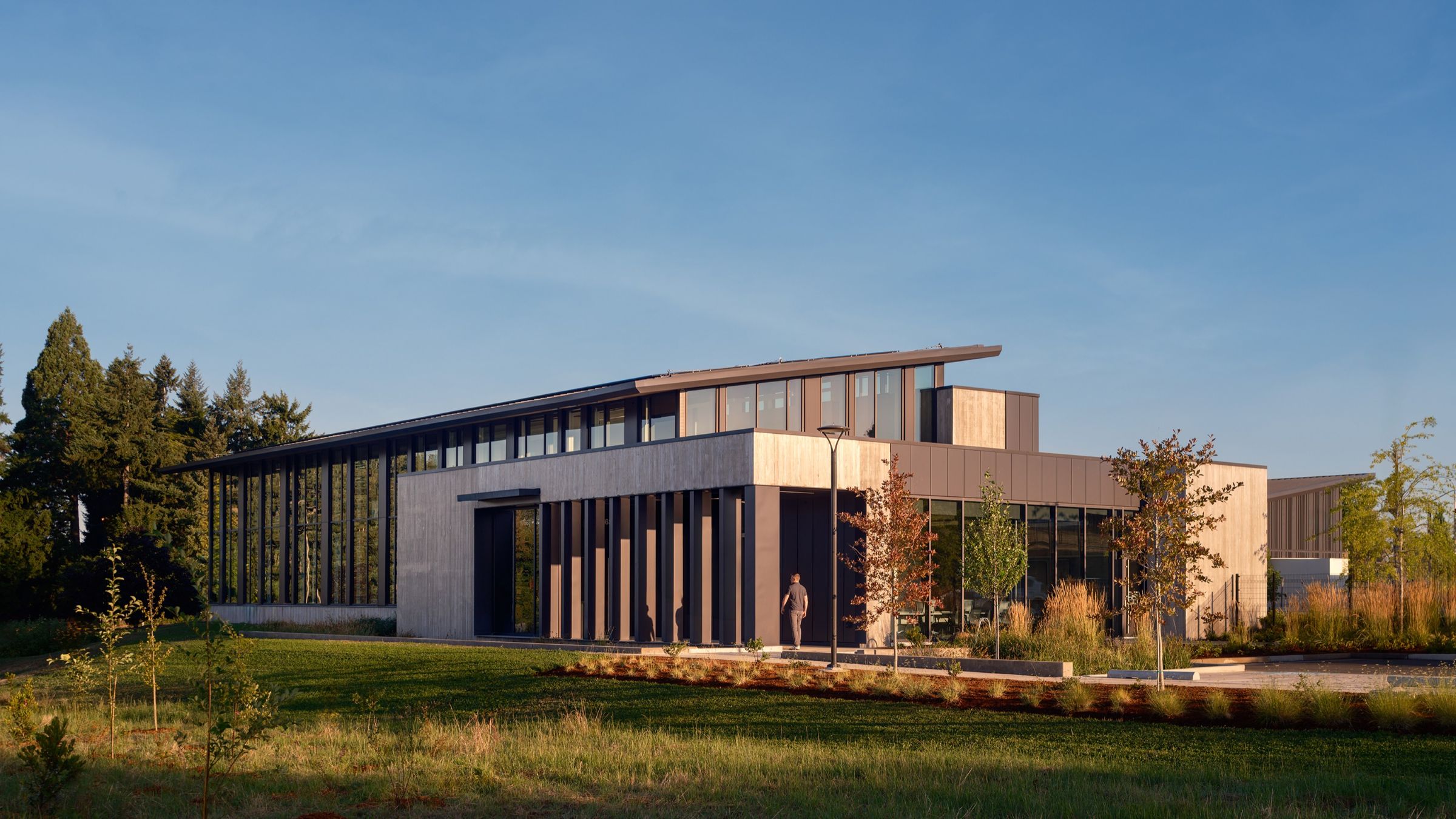 Sunrise Water Authority’s operations campus sits within a landscaped setting, with broad glazing, warm wood accents, and a low, horizontal profile.