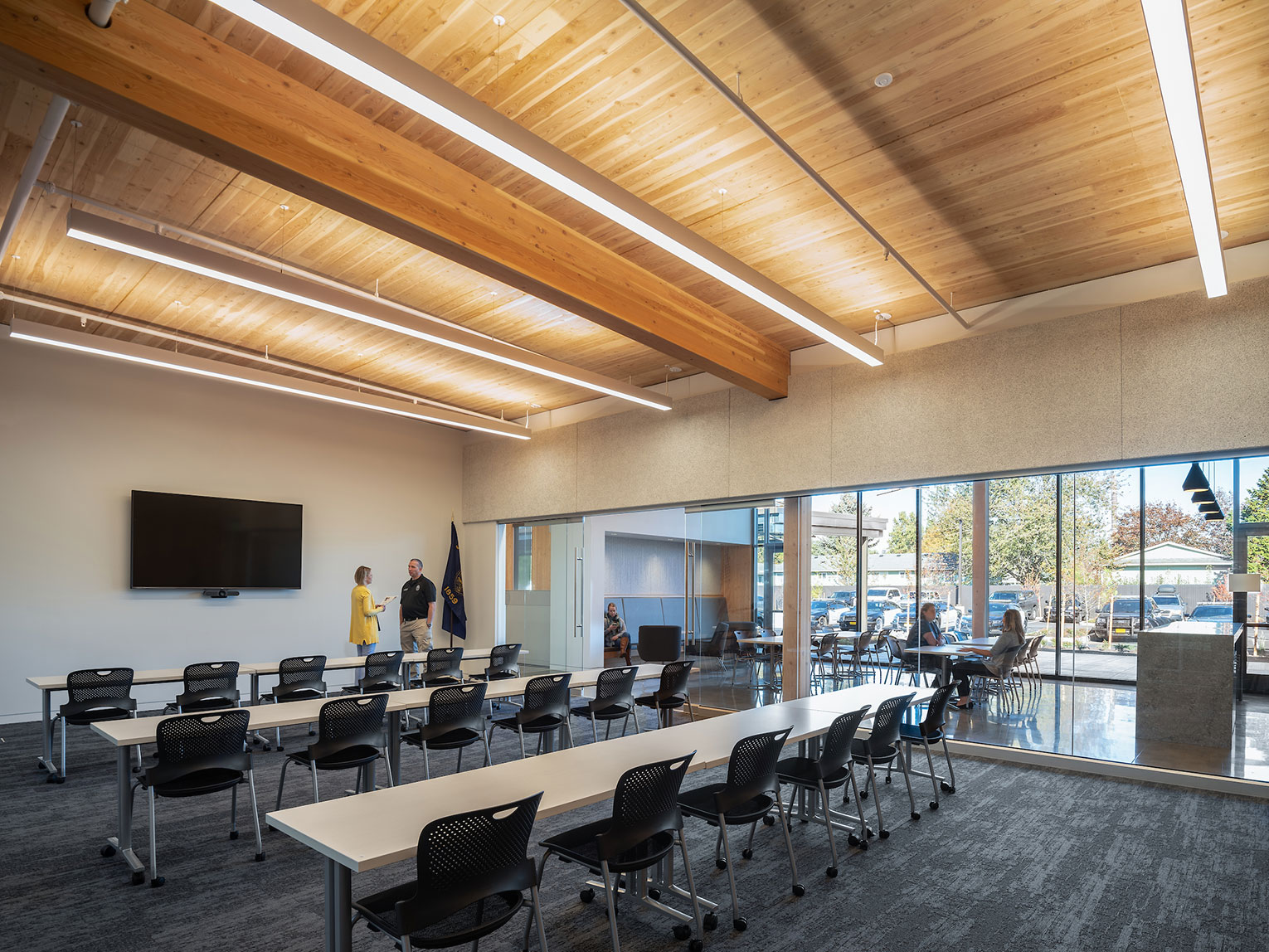 Police briefing room with long tables and views to the outdoors