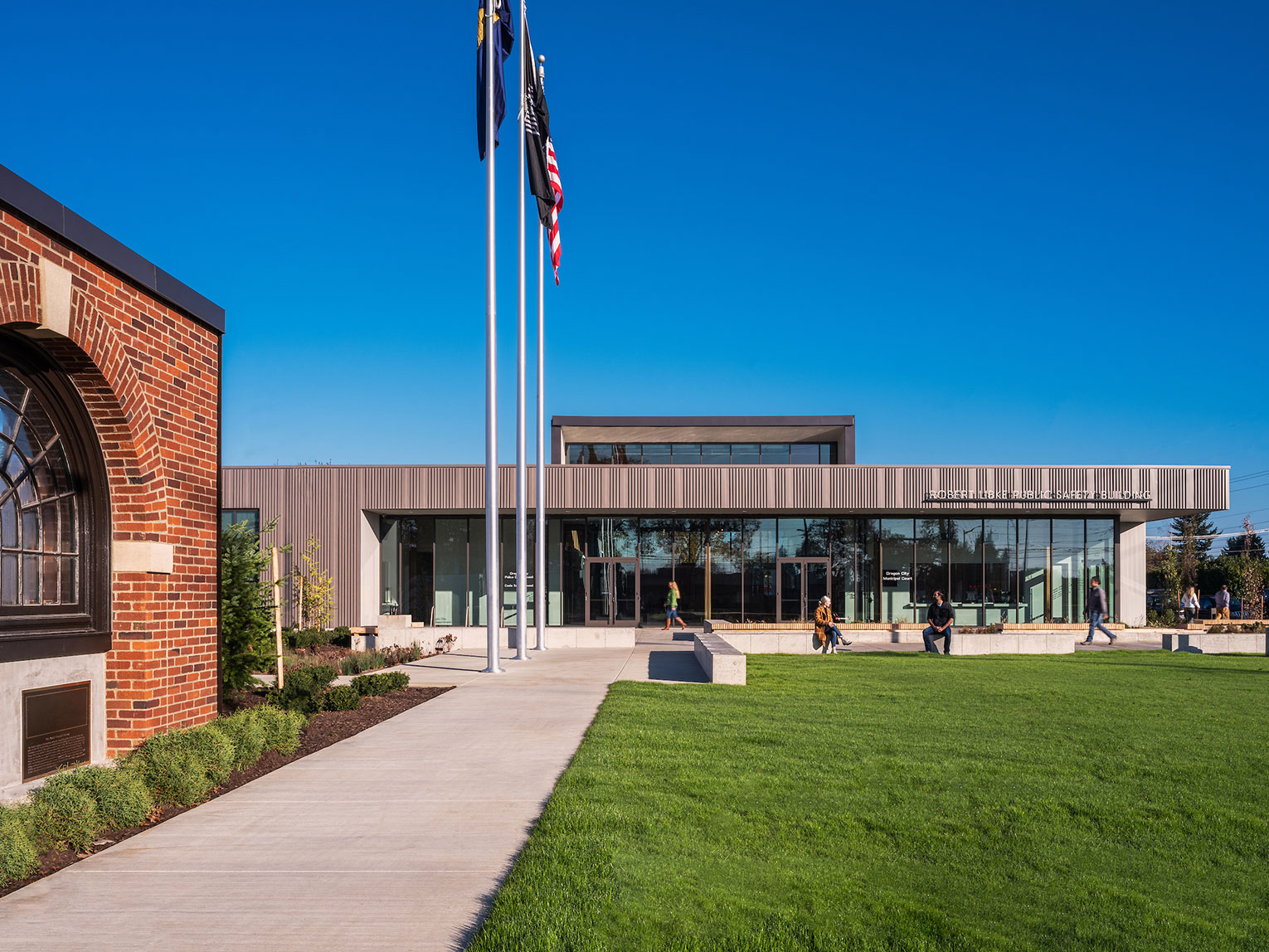 A brick archway which was salvaged from the school on the site greets visitors as the walk toward the new public safety facility in the background