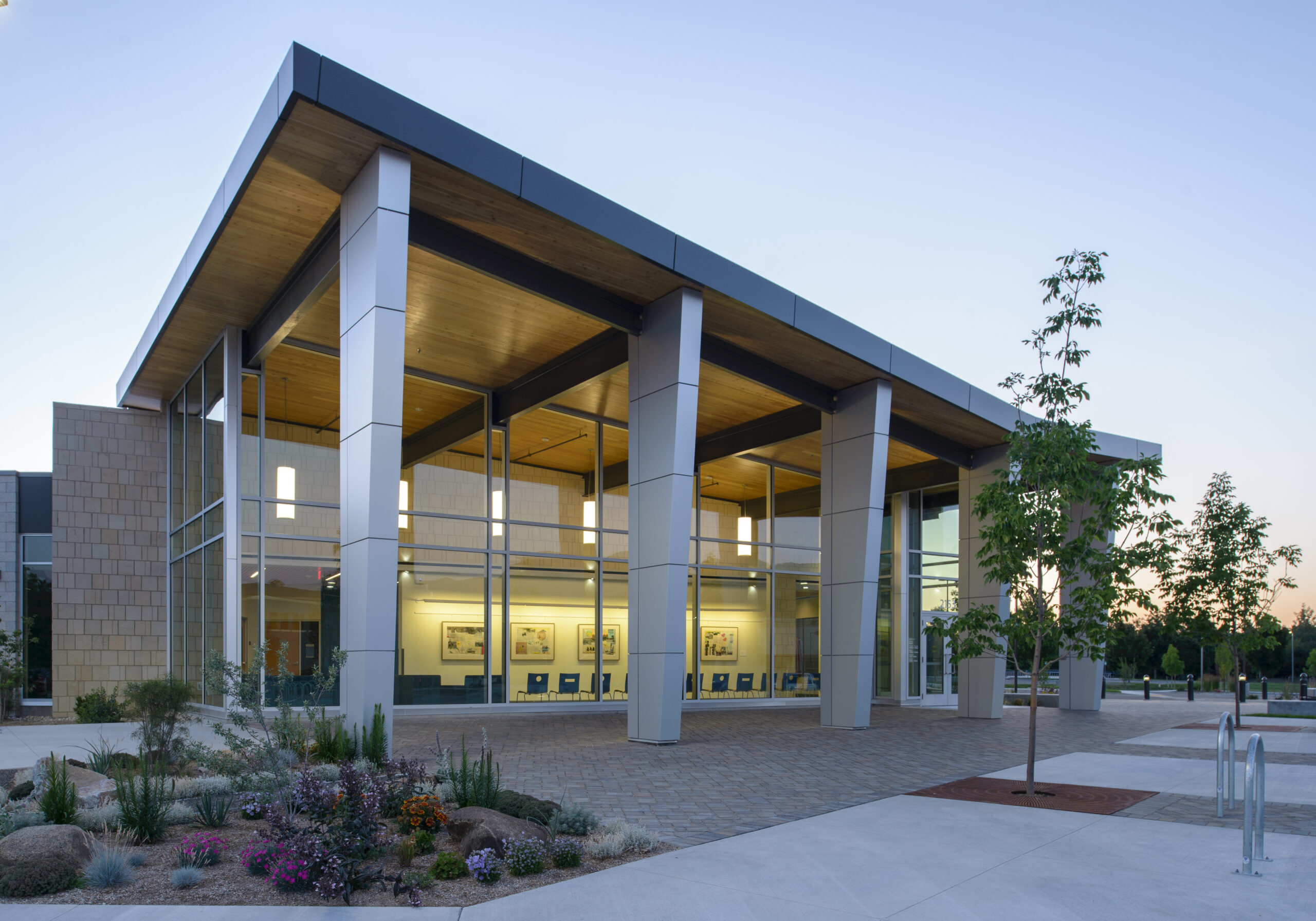 Exterior view of a modern library lit from within