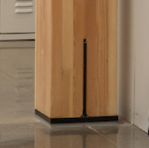 Detail photo of the foot of a mass timber column on a concrete floor