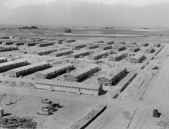 A black and white aerial photo of long barrack housing units at a WW II internment camp for Americans of Japanese decent