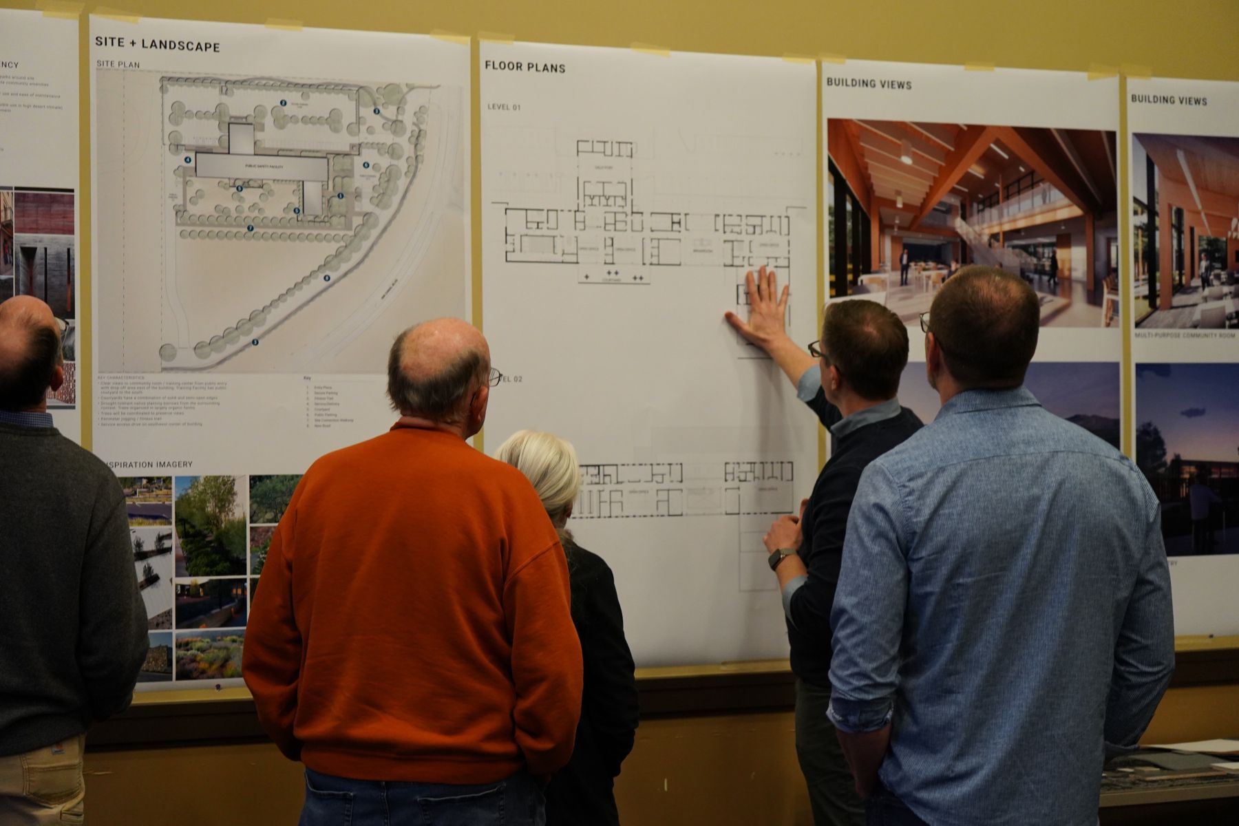 Community members review site plans, floor plans, and design renderings during a Redmond Public Safety Facility project meeting.