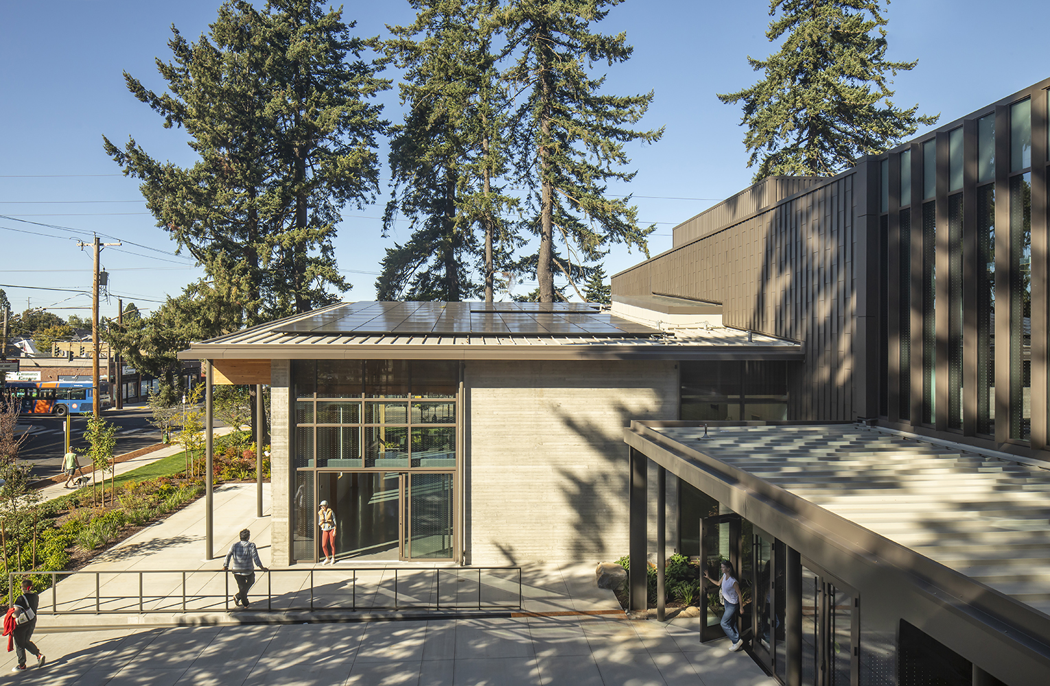 Visitors walk beneath the solar-equipped roof as the Mt. Scott Community Center’s mass-timber addition opens to the surrounding park