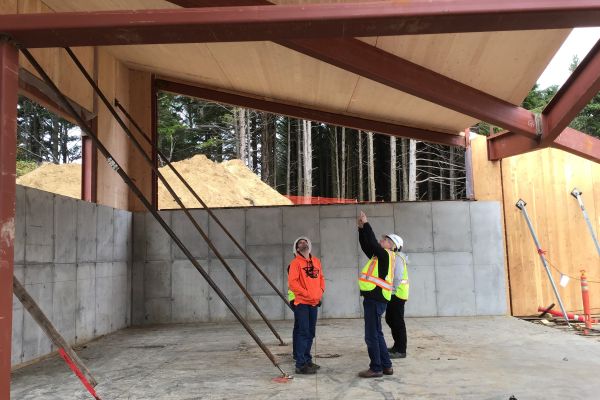 Construction team members inspect the Lincoln City Police Station as its hybrid steel and mass timber structure takes shape.